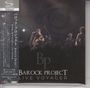 Texte: Barock Project Live Voyager. Szene: Band spielt live, Gitarren, Mikrofone, große Uhr im Hintergrund.