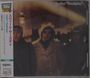 Japanese text along the side, "Sweet Thursday" at the top. Blurry image of three individuals in winter coats.