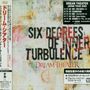 Texte: "SIX DEGREES OF INNER TURBULENCE", "DREAM THEATER", "JAPAN TOUR 2002". Hintergrund: Abstrakte, farbige Muster.