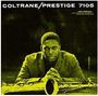 Text: "COLTRANE/PRESTIGE 7105", "John Coltrane". Ein Mann sitzt ernst, ein Saxophon liegt vor ihm. Alles in gelblich-grünen Tönen.