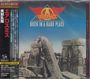 "Aerosmith: Rock in a Hard Place" mit japanischem Text links, darunter historische Steinformation.