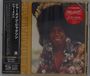 "Jermaine Jackson" und japanische Schriftzeichen. Ein lächelnder Mann in bunter Kleidung und Afrofrisur.