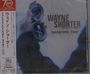 "Wayne Shorter footprints live!" auf grauem Hintergrund, zeigt eine Hand mit einem geöffneten Kompass.