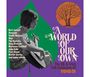 "A World of Our Own" steht groß im Bild. Namen wie Bert Jansch, Donovan und viele andere sind aufgelistet. Links eine Frau mit Gitarre. Oben ein Baum-Logo auf lila Hintergrund.