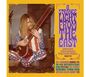 „A Strange Light from the East“ in lila Schrift, 1963-72. Mann in USA-Flaggenkleidung spielt Sitar. Vintage-Plattencover.