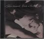 "Steve Winwood Back in the High Life" steht über einem lächelnden Gesicht in Schwarz-Weiß.