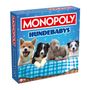"MONOPOLY HUNDEBABYS" steht auf einer Schachtel, die Hundewelpen auf einer karierten Decke zeigt.