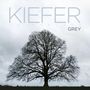 Text: "KIEFER SUTHERLAND GREY". 

Eine große, kahle Baum-Silhouette vor einem grauen, wolkigen Himmel.