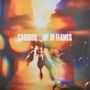 "CARIBOU UP IN FLAMES" in weißer Schrift. Verschwommene, bunte Lichter auf abstraktem Hintergrund.
