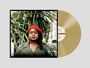 „Limited Edition Gold Vinyl. Zara McFarlane Arise.“ Frau mit rotem Barett vor tropischen Pflanzen, goldene Schallplatte.