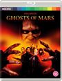 "JOHN CARPENTER'S GHOSTS OF MARS" steht über einem bedrohlichen Gesicht und sechs Personen mit Waffen auf orange-schwarzem Hintergrund.
