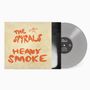 Cover mit orangefarbenem Text "The Spyrals Heavy Smoke". Eine graue Vinylplatte liegt daneben.
