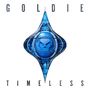 "GOLDIE" oben, "TIMELESS" unten. In der Mitte ein blaues, geometrisches Emblem mit einem stilisierten Gesicht.