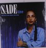 "SADE Live 1984-09-21 Ahoy Hallen, Rotterdam." Frau mit Zopf, blauer Bluse, vor lila Hintergrund.