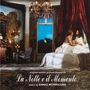 "La Notte e il Momento, music by Ennio Morricone." Zwei Personen sitzen in einem elegant dekorierten, romantischen Raum.