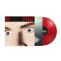 Text: "DE STAAT" in roten Großbuchstaben. Nahaufnahme von blauen Augen, daneben eine rote Vinyl-Schallplatte.