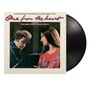 Schrift: "One from the heart", “featuring Tom Waits and Crystal Gayle”. Ein Mann mit Hut sieht auf eine lächelnde Frau.