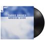 Text: "THREE DRIVES GREECE 2000." Blauer Hintergrund, weiße und blaue Schrift. Links oben "ARMADA MUSIC" neben Logo.