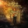 "Joshua Batten TRUE OPTIMISM." Ein Mann mit Gitarre steht an einem Baum in einer sonnendurchfluteten Waldszene.