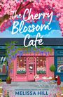 "The Cherry Blossom Café" in Kursivschrift, rosa Hintergrund mit blauem Verlauf. Oben rechts rosa Kreis mit "Cover to be revealed".