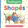"Paddington Shapes" ist der Titel. Ein Bär in blauem Mantel hält ein herzförmiges Sandwich auf einer Bank.