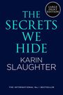 Text: "The Secrets We Hide", "Karin Slaughter", "The International No. 1 Bestseller", "Large Print Edition". Dunkler Hintergrund.