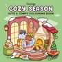 Text: "Coco Wyo Cozy Season Cute & Comfy Colouring Book." Eine gemütliche Szene mit Kamin, Schaukelstuhl, schlafendem Hund und Kaffee.