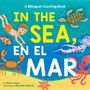 Text: "A Bilingual Counting Book. IN THE SEA, EN EL MAR." Illustrative Darstellung von Meereslebewesen und einem schwimmenden Kind.