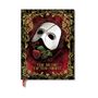 "The Music of the Night" steht darunter. Eine weiße Maske mit einer Rose liegt auf einem roten, reich verzierten Hintergrund.