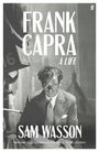 "FRANK CAPRA: A LIFE. SAM WASSON. Ein Mann in Anzug mit ernster Miene sitzt, Kameratechnik sichtbar im Hintergrund."