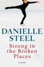„DANIELLE STEEL, Strong in the Broken Places, a novel“. Eiskunstläuferin in schwarzem Outfit auf Eisfläche in Pirouette.