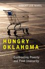 "Robert Lee Maril. Hungry Oklahoma. Confronting Poverty and Food Insecurity." Einkaufswagen auf einem leeren Parkplatz.