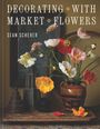 „Decorating with Market Flowers, Sean Scherer“. Ein Bouquet bunter Blumen in einer Vase neben geometrischen Objekten.