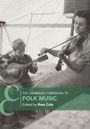 "THE CAMBRIDGE COMPANION TO FOLK MUSIC, Edited by Ross Cole." Zwei Personen spielen Gitarre und Geige in einem Zelt.