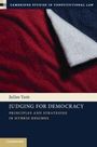 Ein Buchcover mit dem Titel "Judging for Democracy" von Julius Yam, rote und blaue Stofffalten als Hintergrund.