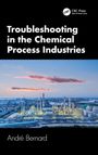 Oben: "Troubleshooting in the Chemical Process Industries." Unten: "André Bernard." Foto einer Industrieanlage bei Abenddämmerung.
