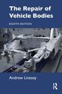 „The Repair of Vehicle Bodies“, achte Auflage, Andrew Livesey. Bild: Eine halb montierte Autokarosserie in einer Werkstatt.