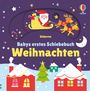 "Babys erstes Schiebebuch Weihnachten" auf lila Hintergrund. Santa in Schlitten, Rentiere, Schneelandschaft, bunte Häuser.