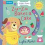 "Zu-Zu Bakes a Cake" steht in roten Buchstaben. Ein Hund in Schürze hält einen Löffel, daneben Kuchen, Erdbeere, Wassermelone.