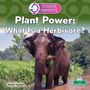 "Plant Power: What Is a Herbivore?" Ein Elefant steht im Wasser und kaut auf Pflanzen. Im Hintergrund grüne Vegetation.