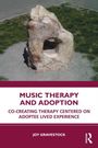 Titel: "Music Therapy and Adoption". Untertitel: "Co-creating Therapy Centered on Adoptee Lived Experience". Autor: Joy Gravestock. 
Ein Stein mit großem Loch steht auf grauem Kies.