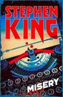 "Stephen King" in großen roten Buchstaben, "Misery" in weiß. Eine alte Schreibmaschine ist abgebildet.