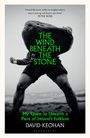 "THE WIND BENEATH THE STONE. My Quest to Unearth a Piece of Ireland's Folklore. DAVID KEOHAN. Schwarz-weißes Foto eines Mannes, der einen großen Stein über dem Kopf hält."