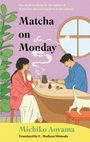 "Matcha on Monday" von Michiko Aoyama. Zwei Personen sitzen beim Tee an einem runden Tisch, eine Katze rechts.