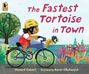 „The Fastest Tortoise in Town“. Kind mit Helm fährt Rad, Schildkröte im Korb. Buntes Laub und Baum sichtbar.