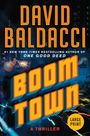 DAVID BALDACCI, BOOM TOWN, A THRILLER. Großstadt bei Nacht mit grellen Lichtern und starkem Gelb-Orange-Kontrast.