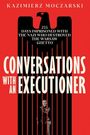 Titel: "Conversations with an Executioner" in Rot auf schwarzem Adler-Design mit kleinem Mann darunter.