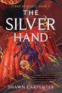 Text: "Tides of Magic, Book II. The Silver Hand. Shawn Carpenter." Illustration: Ein blaues, feuerspeiendes Einhorn vor rotem Hintergrund.