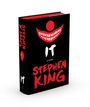 Text: "IT", "A Novel", "Stephen King". Schwarzes Cover mit roten Elementen, darunter ein Clown-Gesicht mit grinsendem Mund.