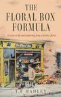 "The Floral Box Formula" von T.F. Hadley. Ein floraler Laden mit zwei Personen davor, umgeben von vielen Blumen.